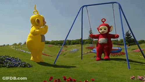 A Yellow Teddy Bear And A Red Teddy Bear Standing Next To A Swing Set GIF