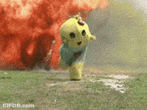 A Yellow Teddy Bear Is Running In Front Of An Explosion In A Field . GIF