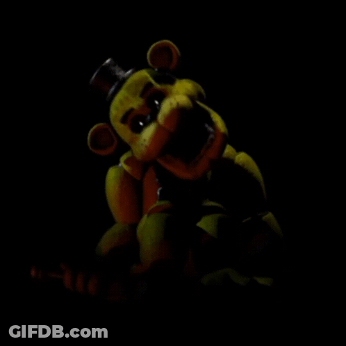 A Yellow Teddy Bear With A Top Hat Is In The Dark . GIF