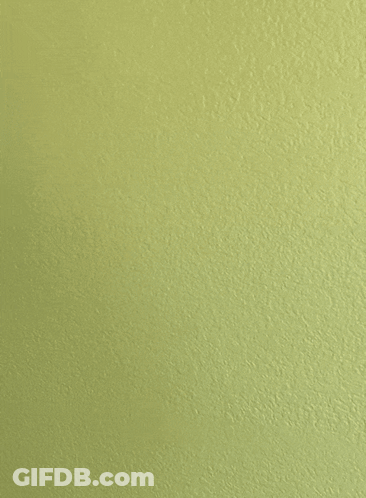 A Yellow Wall With A White Object Against It GIF