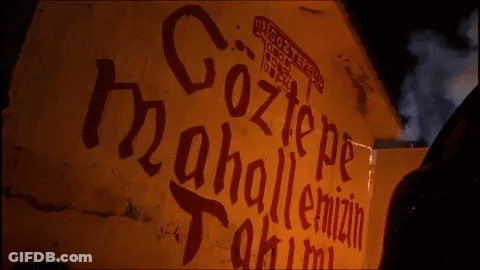 A Yellow Wall With Red Letters That Says Göztepe GIF