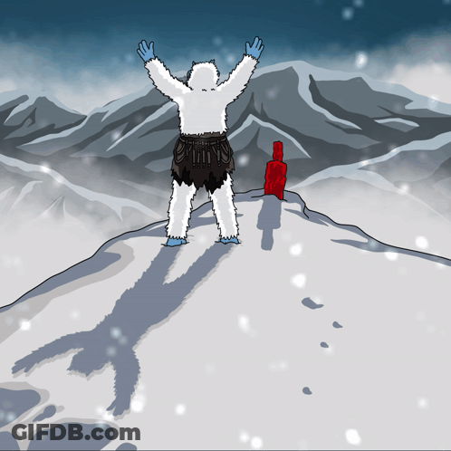 A Yeti Is Standing On Top Of A Snowy Mountain GIF