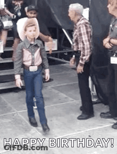 A Young Boy Dressed As A Cowboy Is Walking Towards A Man In A Cowboy Hat . GIF