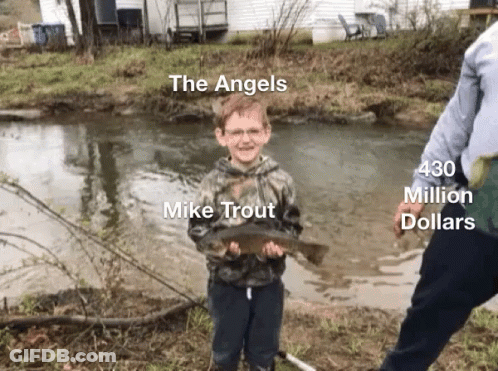 A Young Boy Holding A Fish In Front Of A River With The Words The Angels Mike Trout 430 Million Dollars On The Bottom GIF