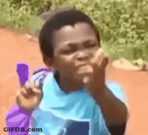 A Young Boy In A Blue Shirt Is Holding A Purple Bag And Blowing A Kiss . GIF