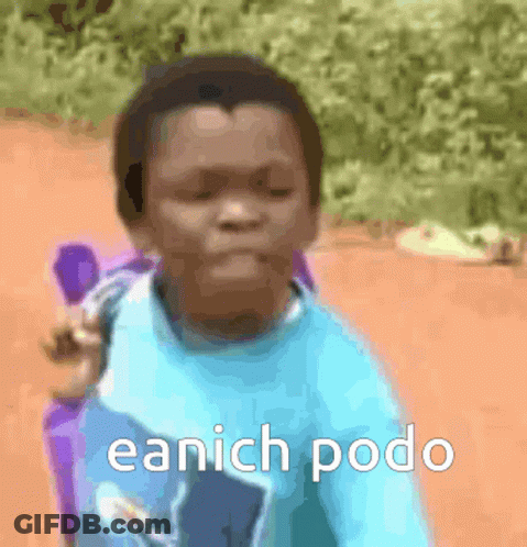 A Young Boy In A Blue Shirt Is Sitting In A Chair With The Words Eanich Podo Written On The Bottom GIF