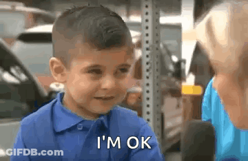 A Young Boy In A Blue Shirt Is Talking To A Woman In A Parking Lot . GIF