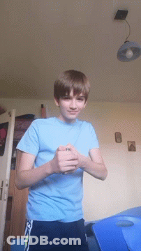 A Young Boy In A Blue Shirt With The Letter N On It GIF