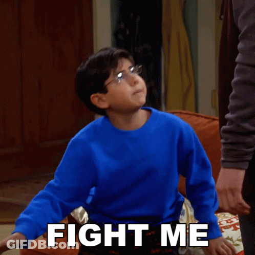A Young Boy In A Blue Sweater Says " Fight Me " GIF