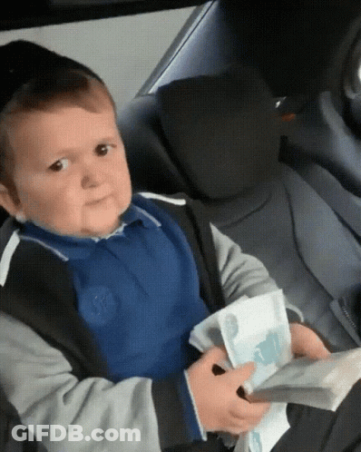 A Young Boy In A Car Seat Holds A Stack Of Money In His Hands GIF