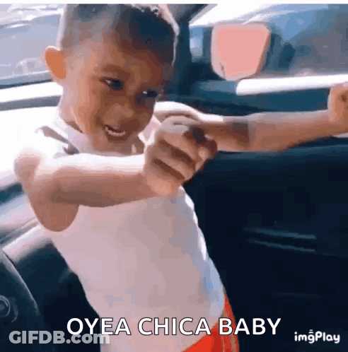 A Young Boy In A Car With The Words Oyea Chica Baby Written On The Bottom GIF