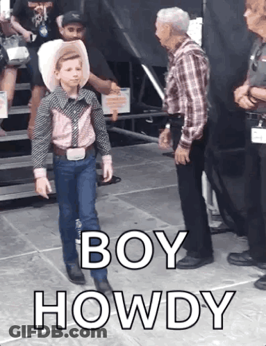 A Young Boy In A Cowboy Outfit Is Standing Next To A Man In A Plaid Shirt And Says Boy Howdy GIF