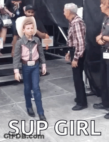 A Young Boy In A Cowboy Outfit Is Standing Next To An Older Man With The Words Sup Girl Below Him GIF