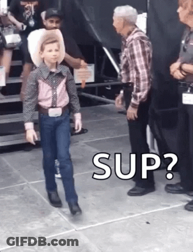 A Young Boy In A Cowboy Outfit Is Walking In Front Of A Man In A Plaid Shirt And Says " Sup " . GIF