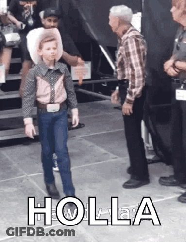 A Young Boy In A Cowboy Outfit Is Walking Towards A Man In A Plaid Shirt With Holla Written On The Bottom Right GIF