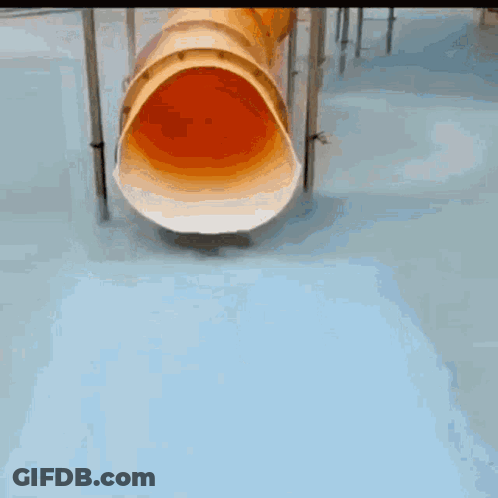 A Young Boy In A Green Shirt Is Playing In A Pool GIF