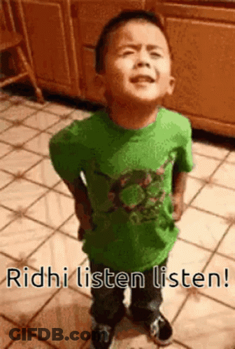 A Young Boy In A Green Shirt Is Standing On A Tiled Floor With The Words Ridhi Listen Listen . GIF
