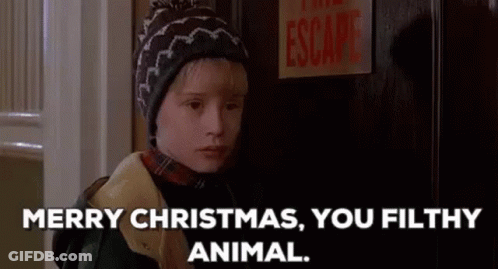 A Young Boy In A Hat Is Standing In Front Of A Door And Says `` Merry Christmas , You Filthy Animal . '' GIF