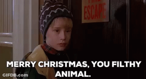 A Young Boy In A Hat Is Standing In Front Of A Door And Says `` Merry Christmas , You Filthy Animal . '' GIF
