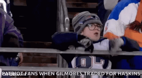 A Young Boy In A Patriots Jersey Is Sitting In The Stands At A Football Game GIF