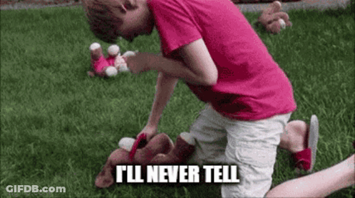 A Young Boy In A Pink Shirt Is Kneeling Down In The Grass With A Stuffed Animal . GIF