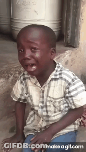 A Young Boy In A Plaid Shirt Is Crying With Tears Running Down His Face GIF