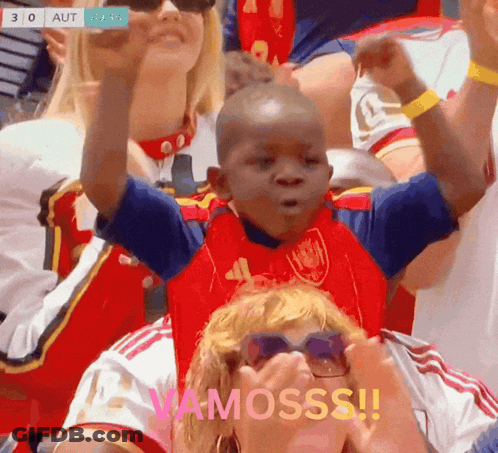 A Young Boy In A Red And Blue Shirt With The Word Vamosss On The Bottom GIF