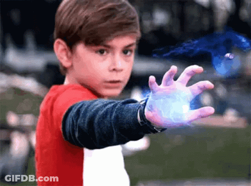 A Young Boy In A Red And White Shirt Is Holding Something In His Hand . GIF