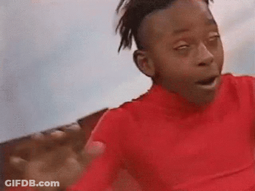 A Young Boy In A Red Shirt Is Making A Funny Face With His Eyes Closed And His Mouth Open . GIF