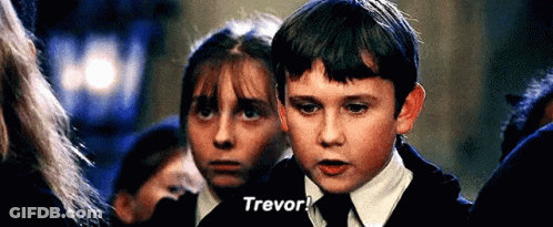 A Young Boy In A School Uniform Is Standing Next To A Girl In A Crowd And Talking To Her . GIF