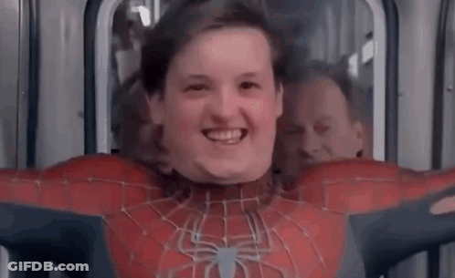 A Young Boy In A Spiderman Costume Is Smiling While Sitting On A Bus . GIF