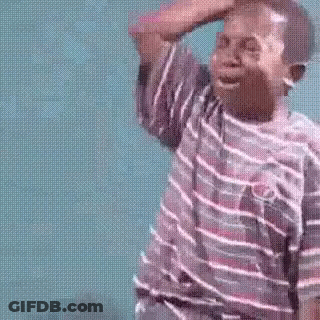 A Young Boy In A Striped Shirt Is Crying While Holding His Hand To His Forehead . GIF