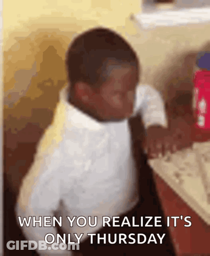 A Young Boy In A White Shirt And Tie Is Sitting At A Table With The Words When You Realize It 'S Only Thursday GIF