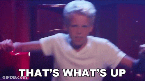 A Young Boy In A White Shirt Is Dancing With The Words That 'S What 'S Up . GIF