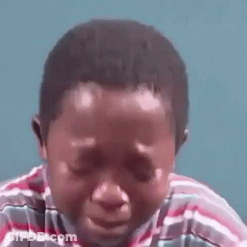 A Young Boy Is Crying With His Eyes Closed . GIF