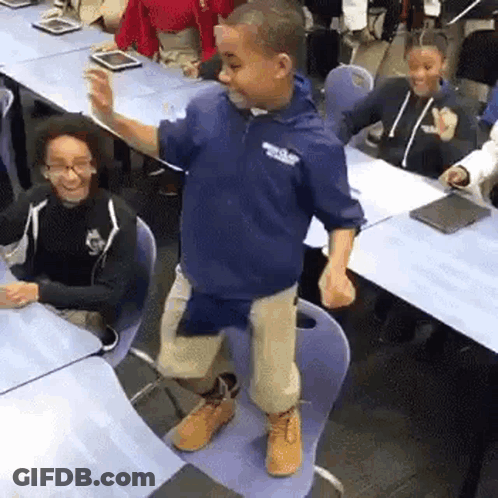 Boy Dancing In Classroom At Table GIF