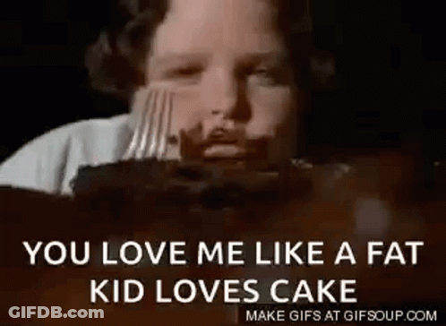 A Young Boy Is Eating A Cake With A Fork . GIF