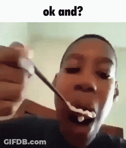 A Young Boy Is Eating A Spoonful Of Cereal With The Words Ok And Written Above Him . GIF