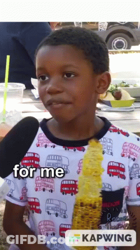 A Young Boy Is Eating Corn On The Cob And The Words For Me Are On The Bottom GIF