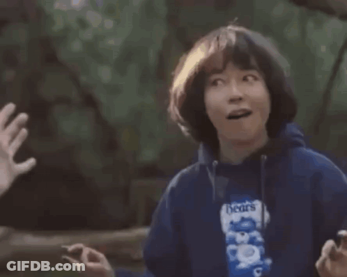 A Young Boy Is Giving A High Five To Another Person While Holding A Bag Of Beans . GIF