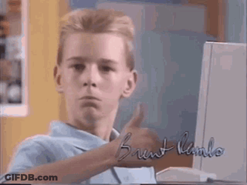 A Young Boy Is Giving A Thumbs Up In Front Of A Computer With The Name Brent Kamlo On It GIF