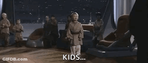 A Young Boy Is Holding A Blue Lightsaber In Front Of A Group Of People . GIF