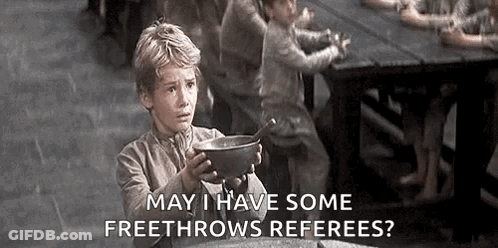 A Young Boy Is Holding A Bowl Of Soup In Front Of A Table . GIF