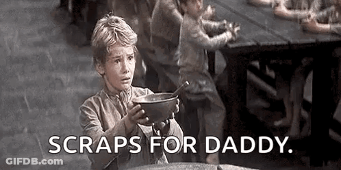 A Young Boy Is Holding A Bowl Of Soup With The Words `` Scraps For Daddy '' . GIF