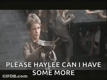 A Young Boy Is Holding A Bowl With A Spoon In It And Asking For Some More . GIF