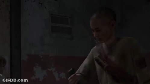 A Young Boy Is Holding A Flashlight In His Hand In A Dark Room . GIF