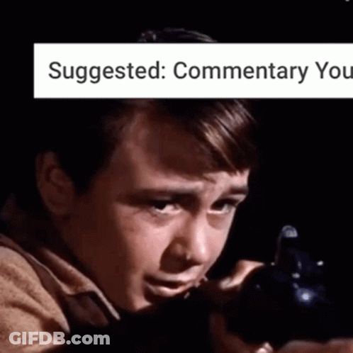 A Young Boy Is Holding A Gun In A Dark Room With The Words Suggested : Commentary You Above Him . GIF