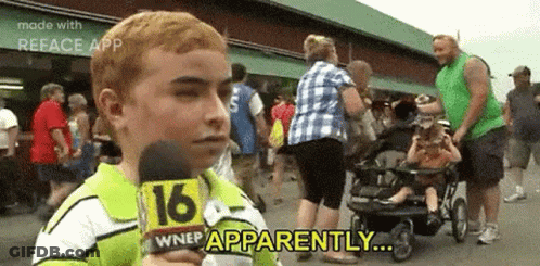 A Young Boy Is Holding A Microphone In Front Of A Crowd Of People And Says `` Apparently '' . GIF