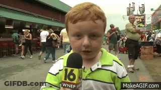 A Young Boy Is Holding A Microphone That Says 16 On It GIF