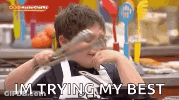 A Young Boy Is Holding A Pair Of Tongs In His Hand And Saying `` I 'M Trying My Best '' GIF